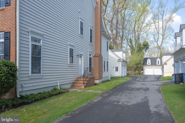 view of side of property featuring an outbuilding and a residential view