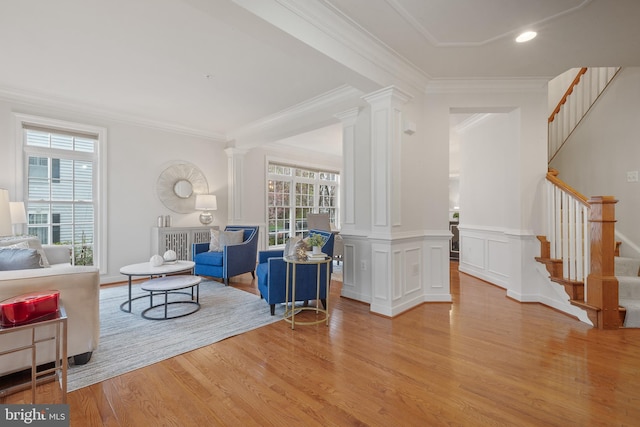 interior space with crown molding, ornate columns, recessed lighting, wood finished floors, and stairs