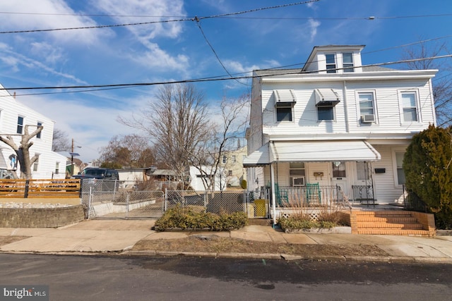 traditional style home with a fenced front yard and a gate