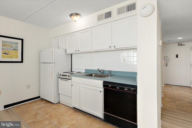 kitchen featuring white appliances, visible vents, decorative backsplash, and a sink