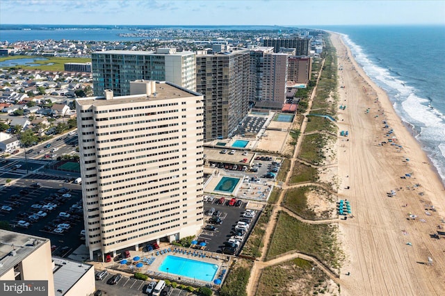 aerial view featuring a view of city, a beach view, and a water view