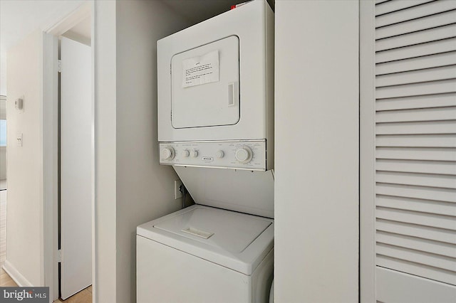 laundry room with stacked washing maching and dryer