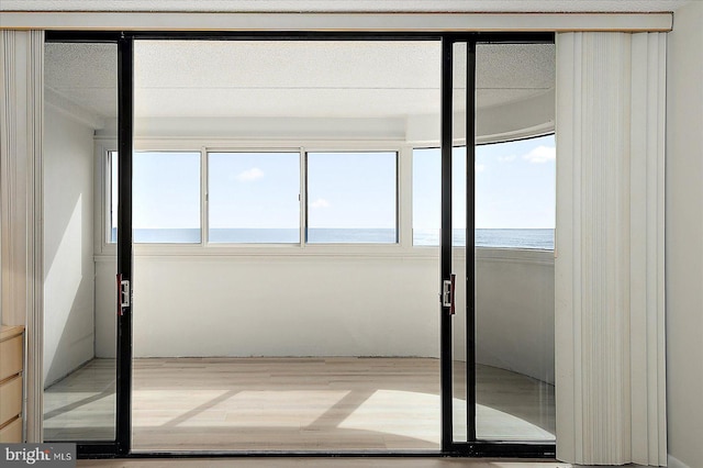 unfurnished sunroom featuring a water view and a wealth of natural light