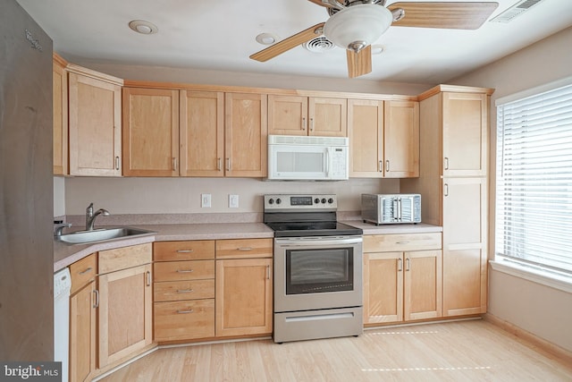 kitchen with visible vents, a ceiling fan, light brown cabinetry, a sink, and appliances with stainless steel finishes