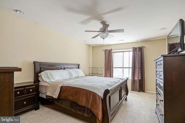 bedroom with ceiling fan, baseboards, visible vents, and light carpet