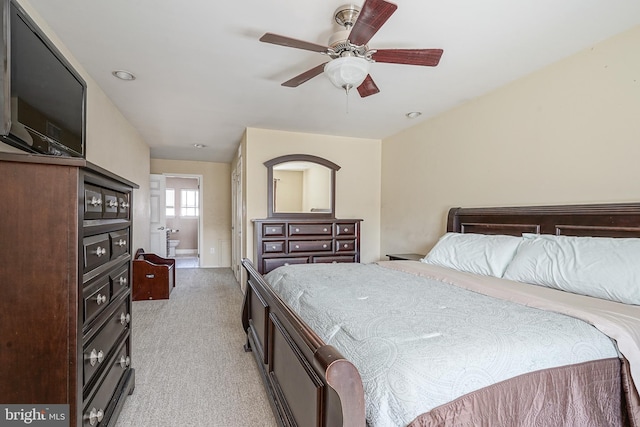 bedroom with a ceiling fan and light carpet