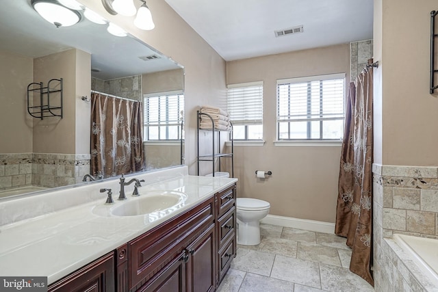 full bath featuring tiled bath, visible vents, baseboards, toilet, and vanity