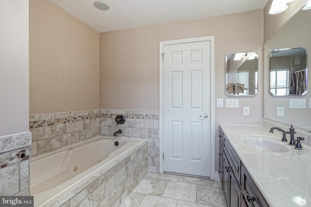 full bath featuring vanity and a tub with jets