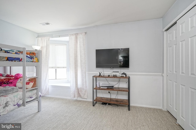 bedroom featuring a closet, visible vents, and carpet floors