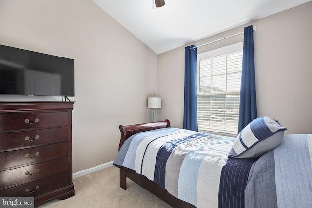 bedroom featuring baseboards, light carpet, ceiling fan, and vaulted ceiling