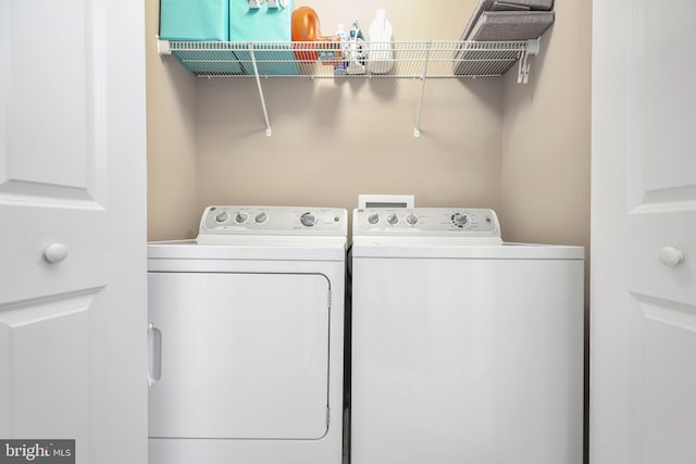 laundry room with washing machine and clothes dryer and laundry area