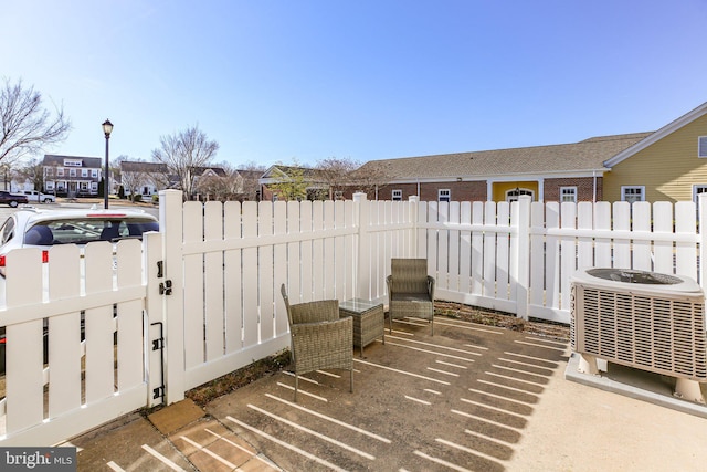 view of patio with central AC unit and a fenced backyard