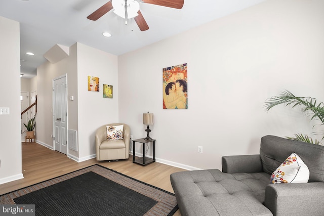 sitting room with a ceiling fan, wood finished floors, visible vents, baseboards, and recessed lighting