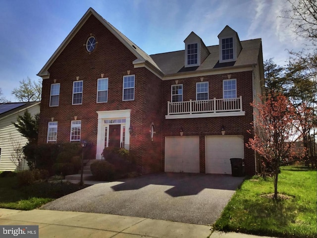 view of front of home featuring an attached garage, aphalt driveway, and brick siding