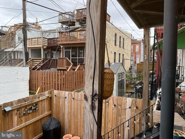 exterior space featuring a balcony and fence