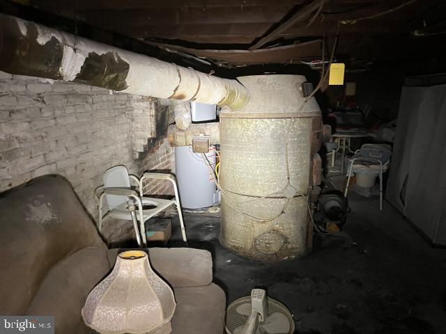 utility room featuring water heater