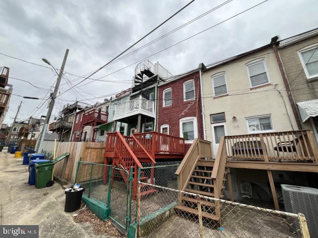 view of jungle gym with stairway, a residential view, fence, and a wooden deck