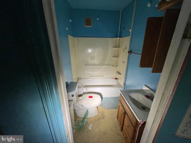 full bath featuring visible vents, toilet, tile patterned floors, vanity, and shower / washtub combination