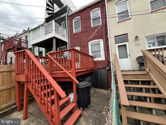 exterior space featuring a wooden deck and stairs