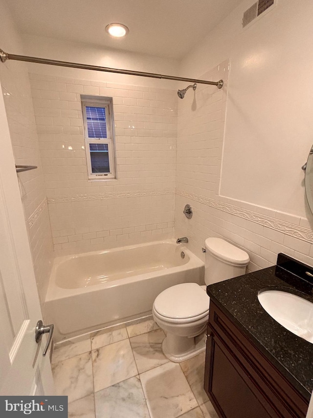 bathroom with marble finish floor, visible vents, toilet, vanity, and  shower combination