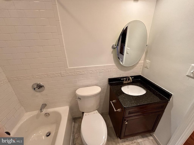 full bathroom with tile walls, shower / bathtub combination, toilet, wainscoting, and vanity