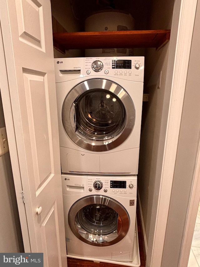 laundry area with stacked washer / dryer and laundry area