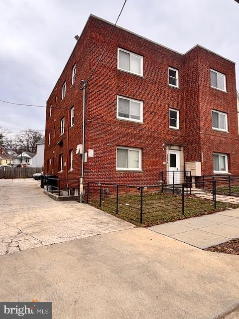 view of building exterior featuring a fenced front yard