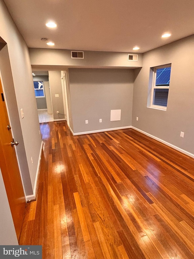 interior space with hardwood / wood-style floors, recessed lighting, visible vents, and baseboards