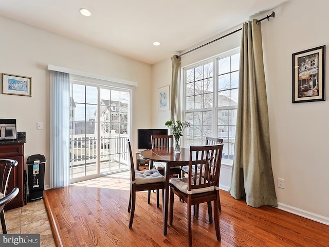 dining space with light wood-type flooring, baseboards, and recessed lighting