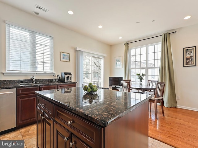 kitchen featuring stainless steel dishwasher, a wealth of natural light, and recessed lighting