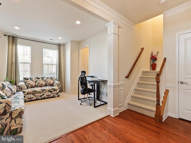 living area with recessed lighting, wood finished floors, visible vents, decorative columns, and crown molding