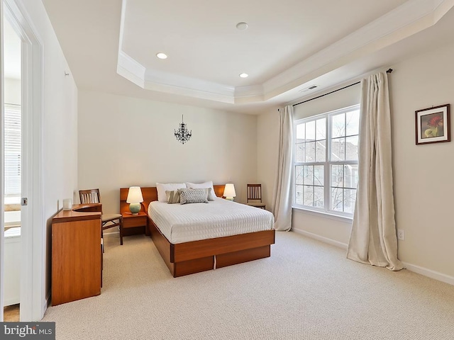 carpeted bedroom with baseboards, visible vents, ornamental molding, a tray ceiling, and recessed lighting