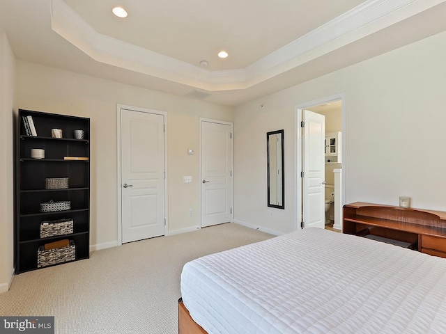 bedroom with a tray ceiling, light colored carpet, baseboards, and recessed lighting