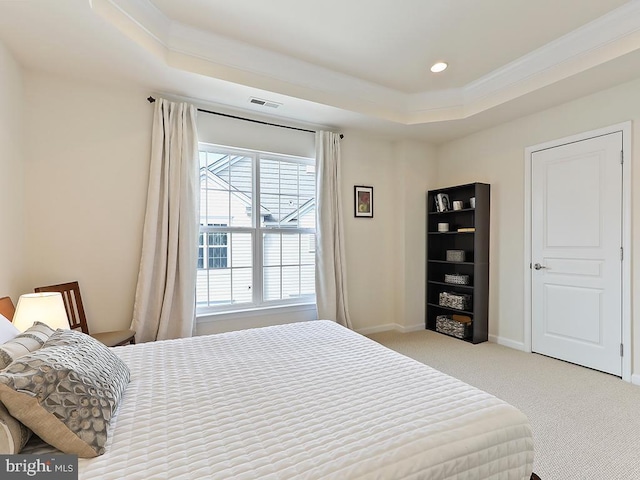 bedroom featuring a tray ceiling, crown molding, visible vents, carpet flooring, and baseboards