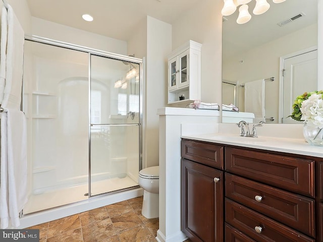 full bathroom with toilet, a stall shower, vanity, and visible vents