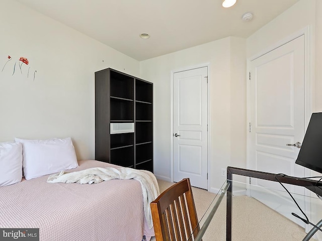 bedroom with light carpet, recessed lighting, and baseboards