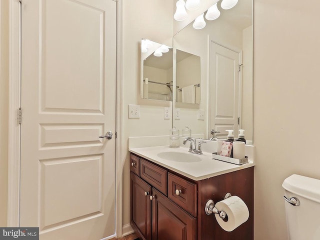 bathroom featuring toilet and vanity