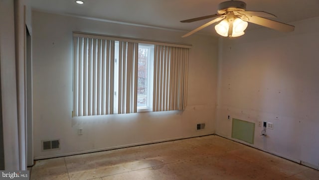 spare room featuring ceiling fan and visible vents