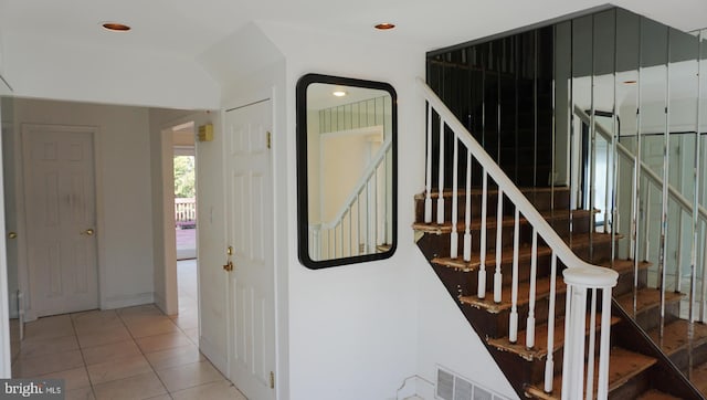 stairs with tile patterned flooring, visible vents, and recessed lighting