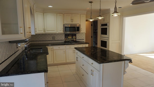 kitchen featuring light tile patterned floors, stainless steel appliances, a sink, ornamental molding, and backsplash