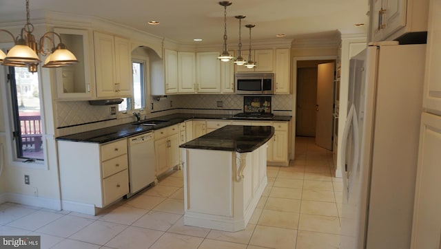 kitchen featuring white appliances, a kitchen island, decorative backsplash, and light tile patterned floors