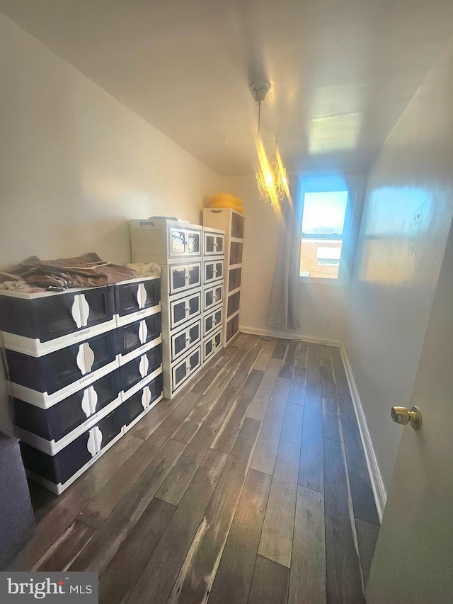 bonus room with wood-type flooring and baseboards