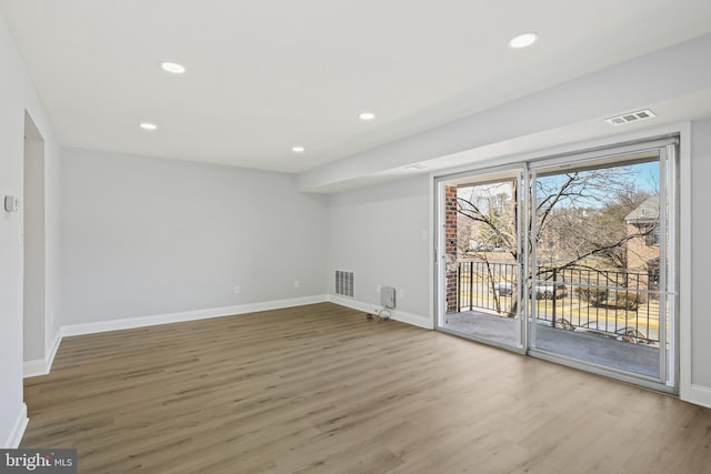 interior space featuring wood finished floors, visible vents, and recessed lighting