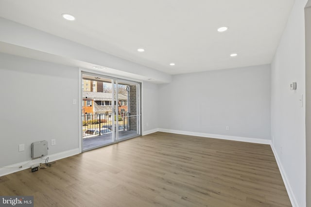 unfurnished room with recessed lighting, baseboards, and wood finished floors