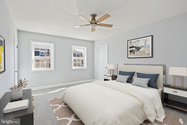 bedroom featuring carpet, a ceiling fan, and baseboards