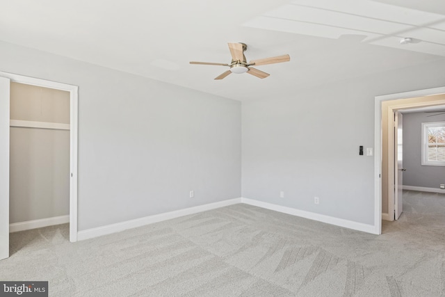 unfurnished bedroom with ceiling fan, carpet flooring, and baseboards