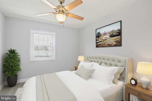 carpeted bedroom featuring a ceiling fan and baseboards