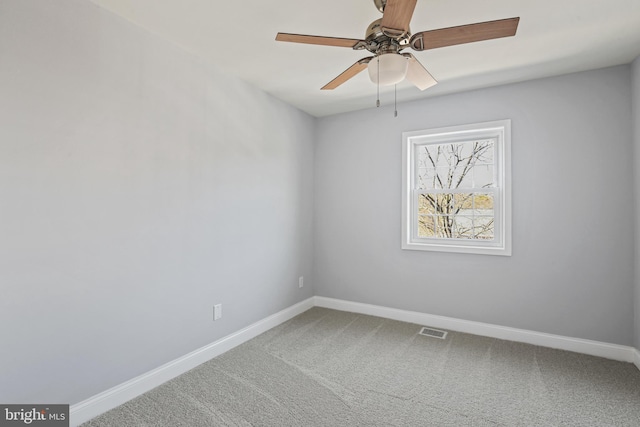 spare room featuring a ceiling fan, baseboards, visible vents, and carpet flooring