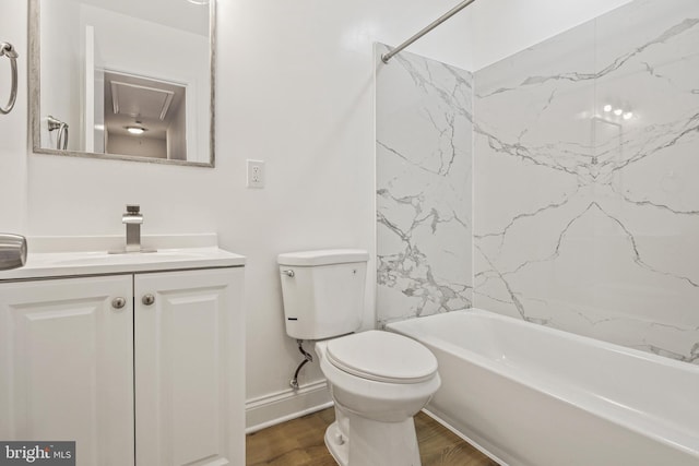 bathroom with vanity, shower / bath combination, wood finished floors, and toilet