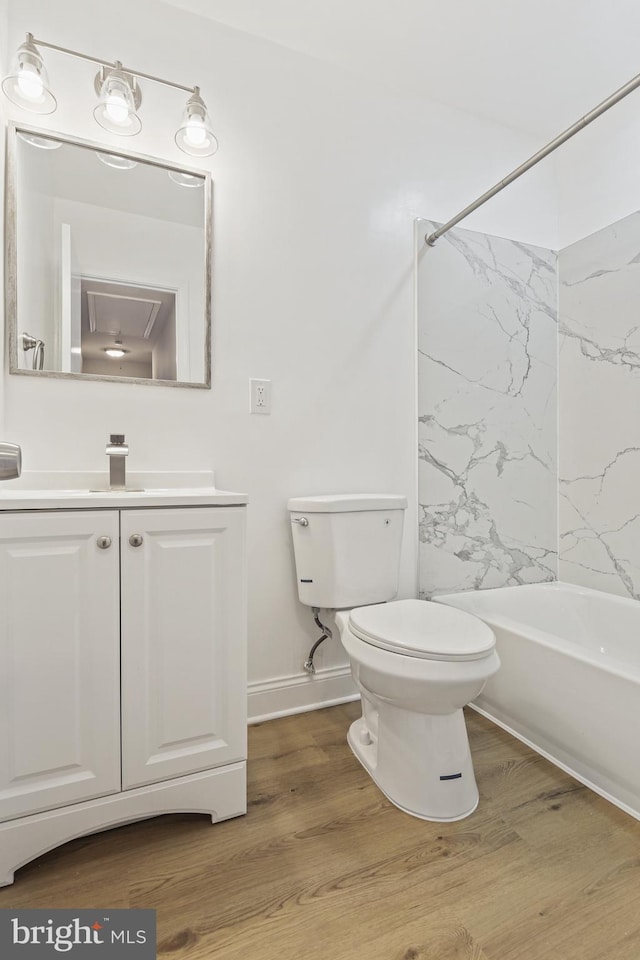 bathroom with vanity, bathing tub / shower combination, toilet, and wood finished floors